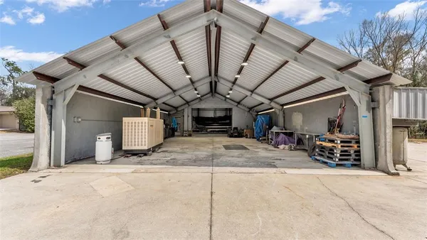 a view of a house with backyard and a tree