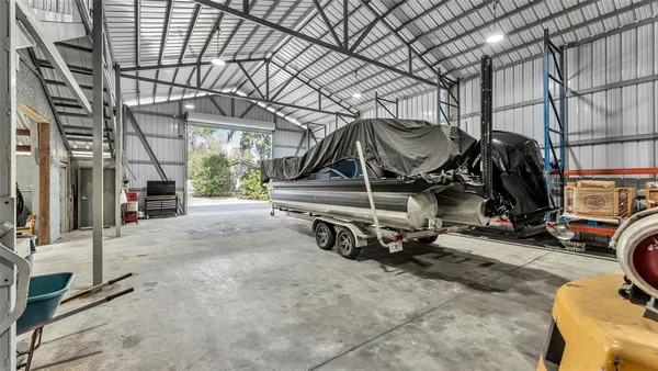an aerial view of a house with a yard and a large tree