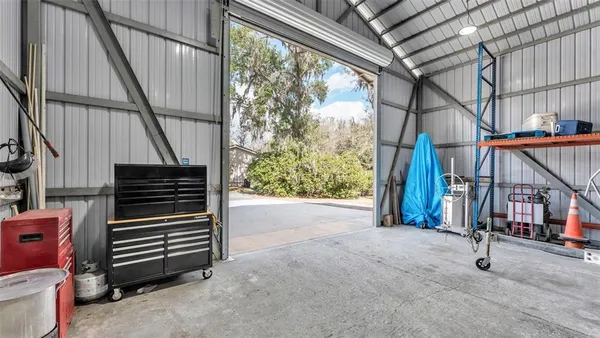 a view of a house with a yard and trees
