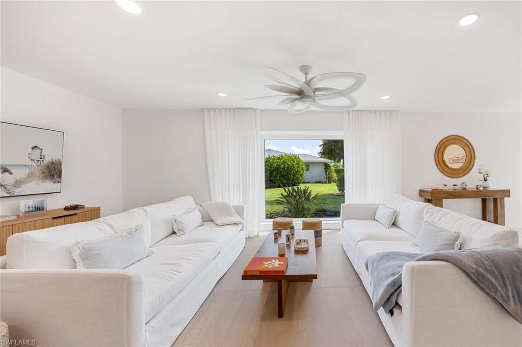 24 Rivard Road Naples, FL 34112 - Photo 11 of 33 a living room with furniture ceiling fan and a window