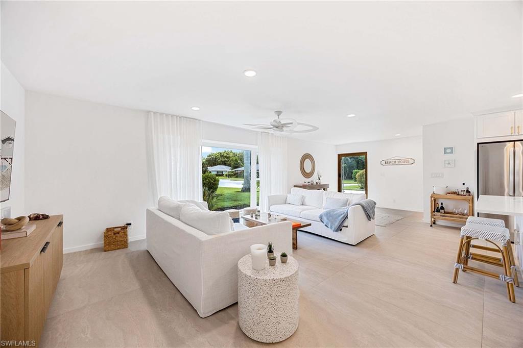 24 Rivard Road Naples, FL 34112 - Photo 12 of 33 a living room with furniture and a flat screen tv
