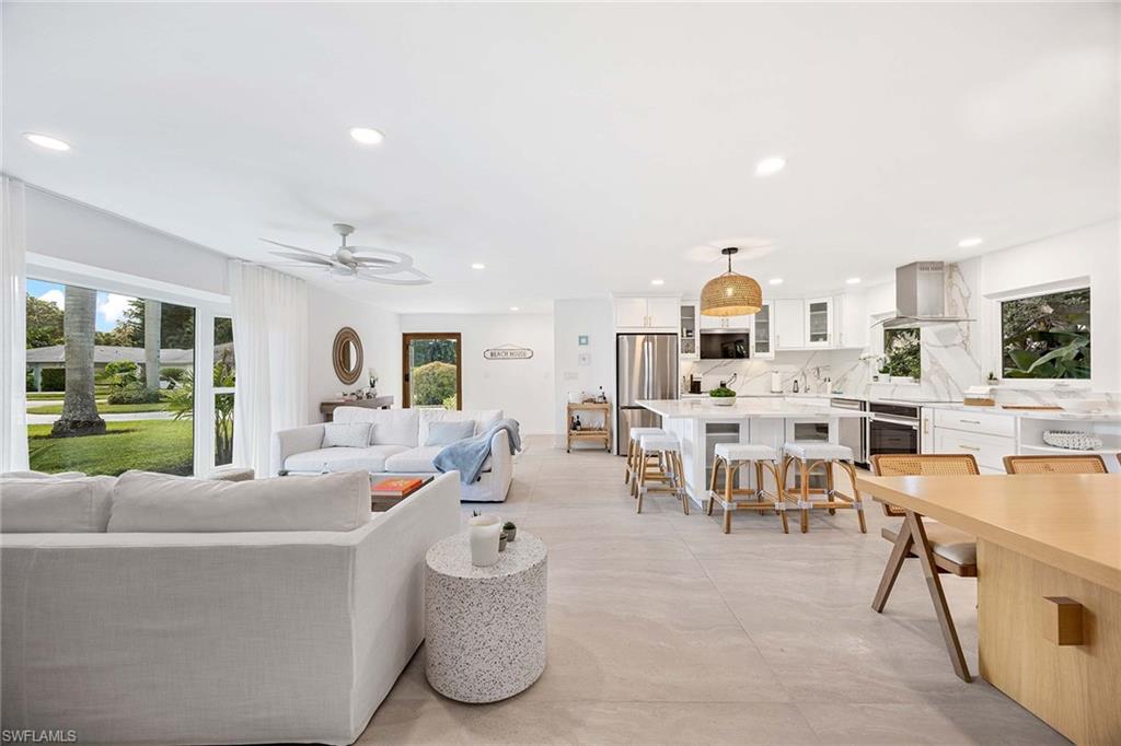 24 Rivard Road Naples, FL 34112 - Photo 13 of 33 a living room with furniture and a large window