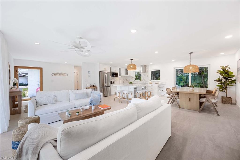 24 Rivard Road Naples, FL 34112 - Photo 14 of 33 a living room with furniture and a large window