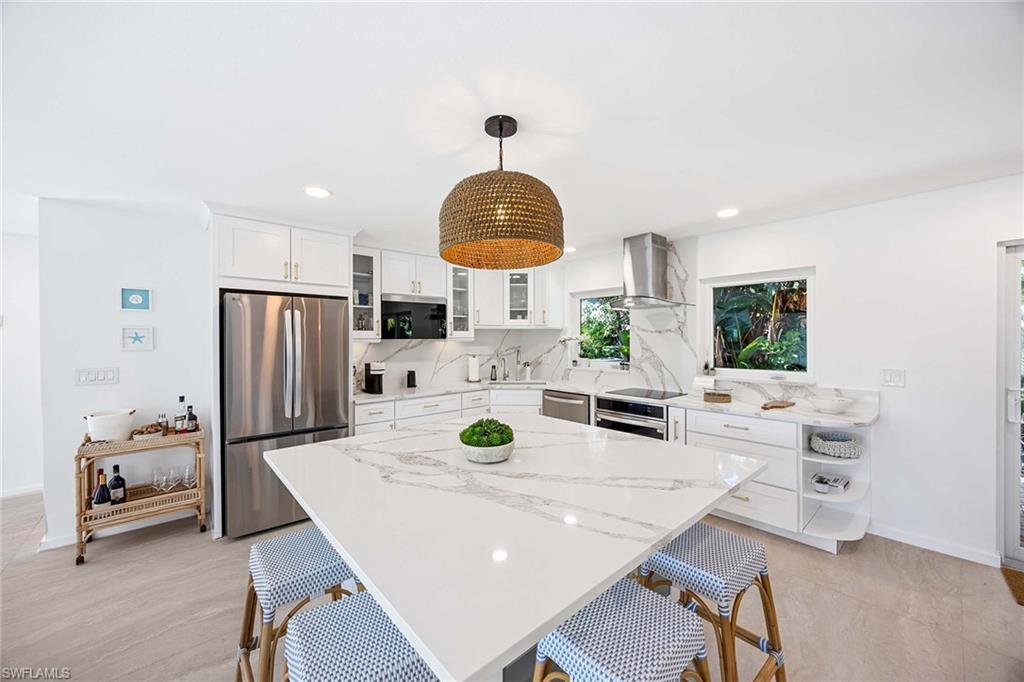 24 Rivard Road Naples, FL 34112 - Photo 17 of 33 a view of a dining room with a table and chairs