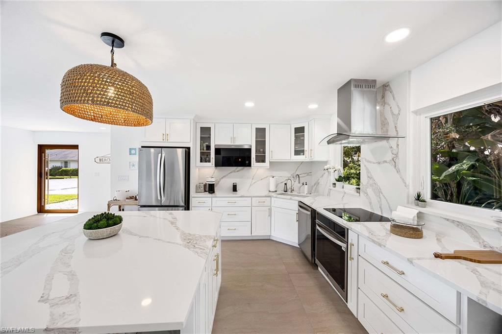 24 Rivard Road Naples, FL 34112 - Photo 18 of 33 a kitchen with cabinets and window