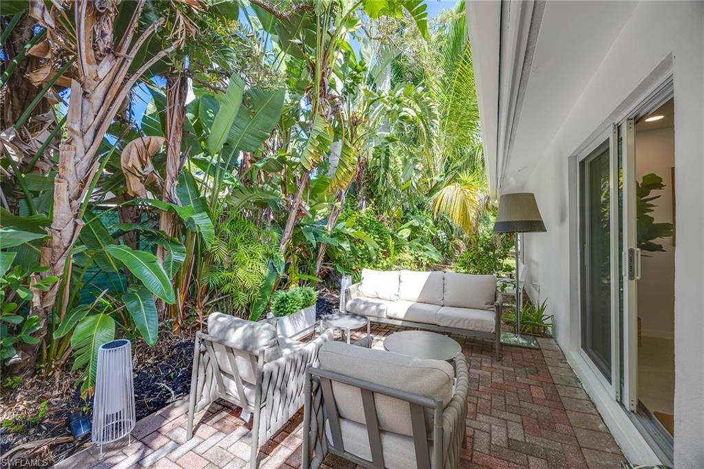 24 Rivard Road Naples, FL 34112 - Photo 29 of 33 a view of backyard with outdoor seating and green space