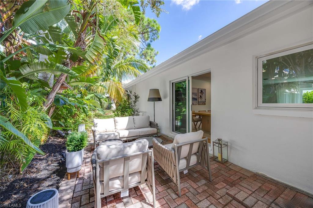 24 Rivard Road Naples, FL 34112 - Photo 30 of 33 a view of a house with backyard and sitting area