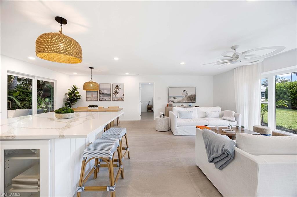 24 Rivard Road Naples, FL 34112 - Photo 10 of 33 a living room with furniture and a large window
