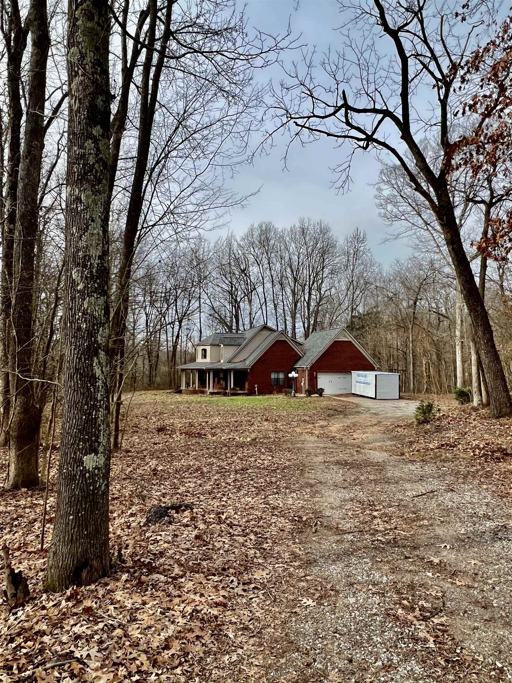 2522 Dunlap Orphanage Road Brighton, TN 38011 - Photo 4 of 22 a view of a dirt yard with a large tree