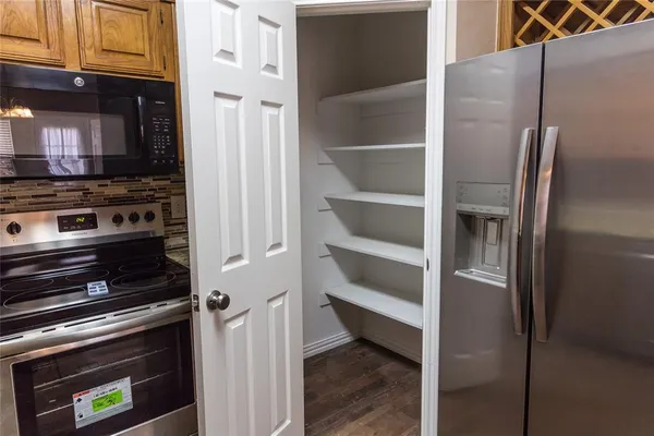 a kitchen with a refrigerator and a stove