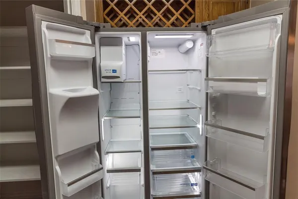 a empty refrigerator with wooden floor