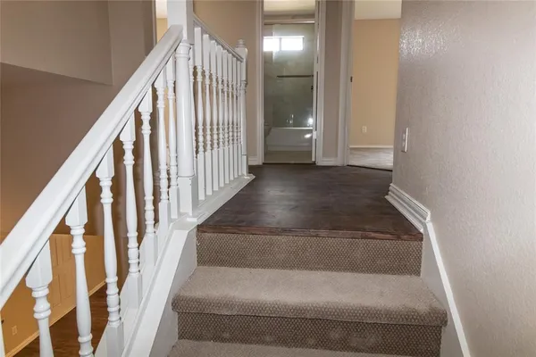 a view of staircase with wooden floor and stairs
