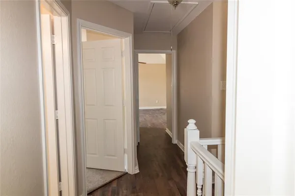a view of a room with wooden floor