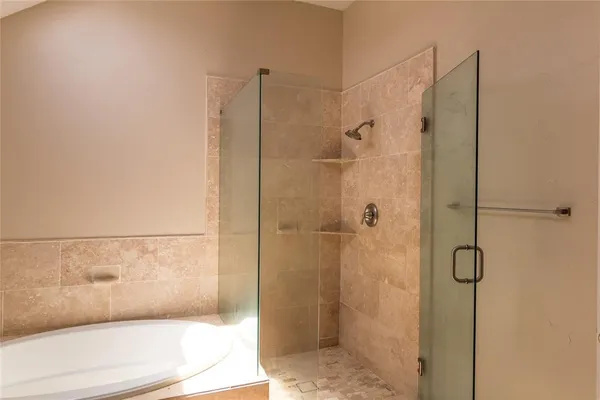 a bathroom with a bathtub and a shower
