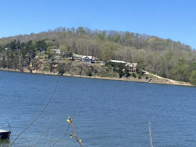 a view of a house with a mountain and a forest