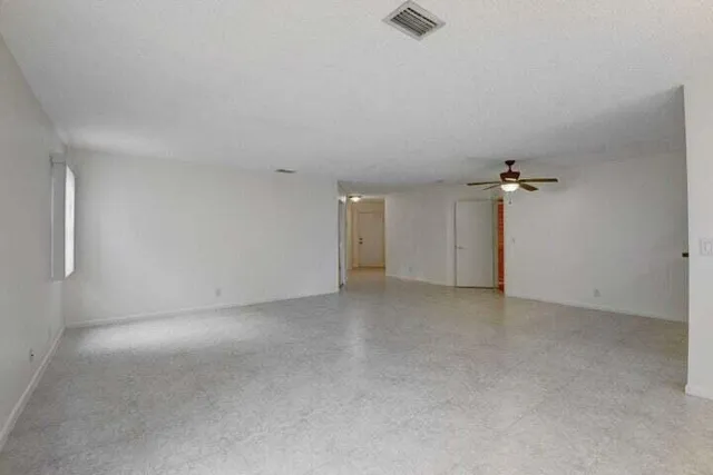 a view of an empty room with glass door