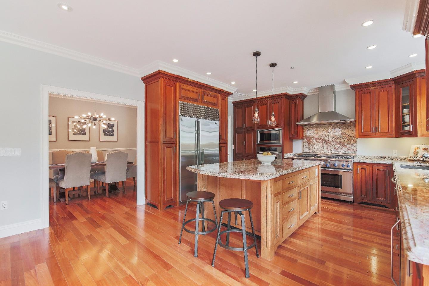 1637 Westmoor Road Burlingame, CA 94010 - Photo 20 of 54 a kitchen with stainless steel appliances granite countertop a stove top oven a refrigerator a sink and a dining table with wooden floor