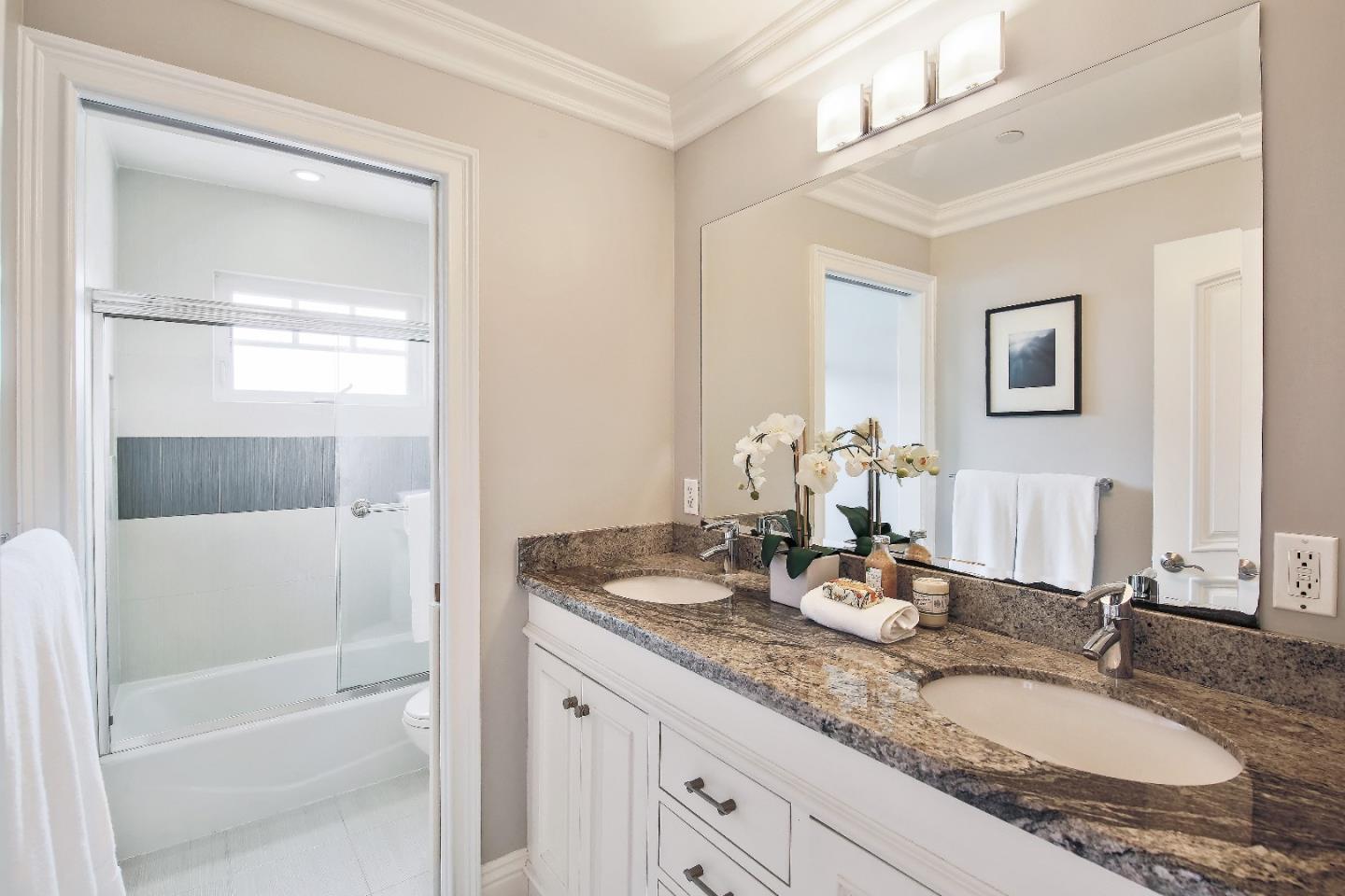 1637 Westmoor Road Burlingame, CA 94010 - Photo 45 of 54 a bathroom with a granite countertop sink and a mirror