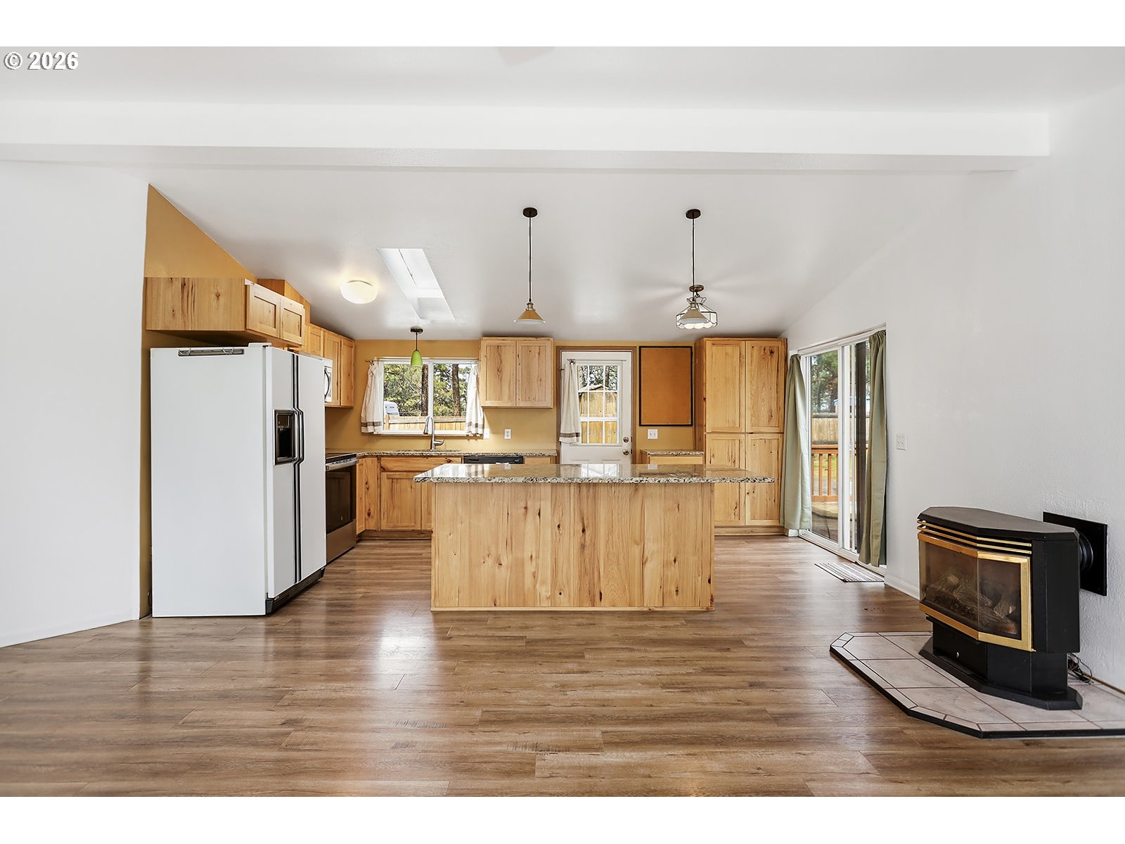 39 North Eagle Point Road Tygh Valley, OR 97063 - Photo 14 of 34 a view of a kitchen with kitchen island white cabinets and wooden floor
