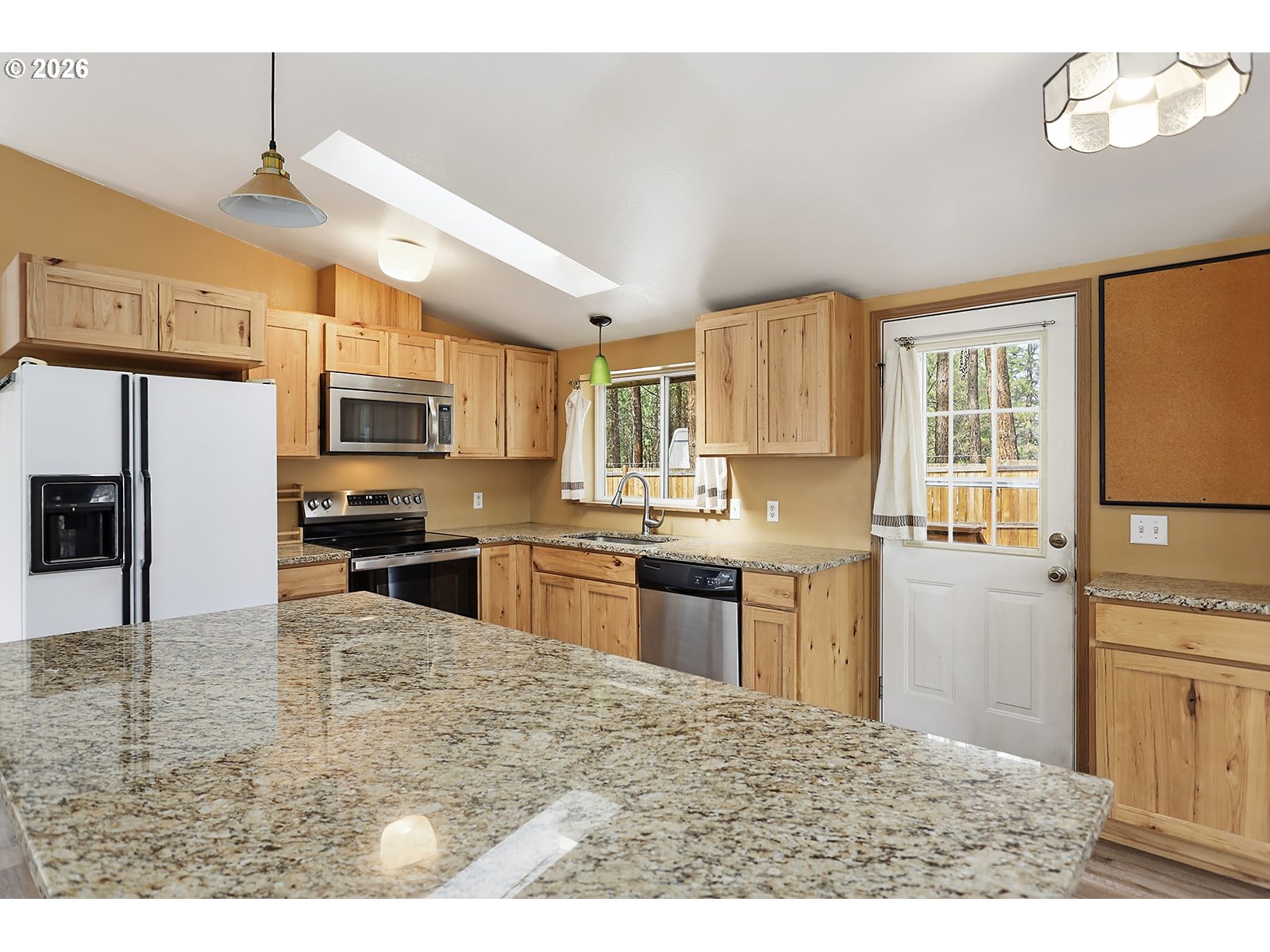 39 North Eagle Point Road Tygh Valley, OR 97063 - Photo 8 of 34 a kitchen with stainless steel appliances granite countertop a sink refrigerator stove and microwave