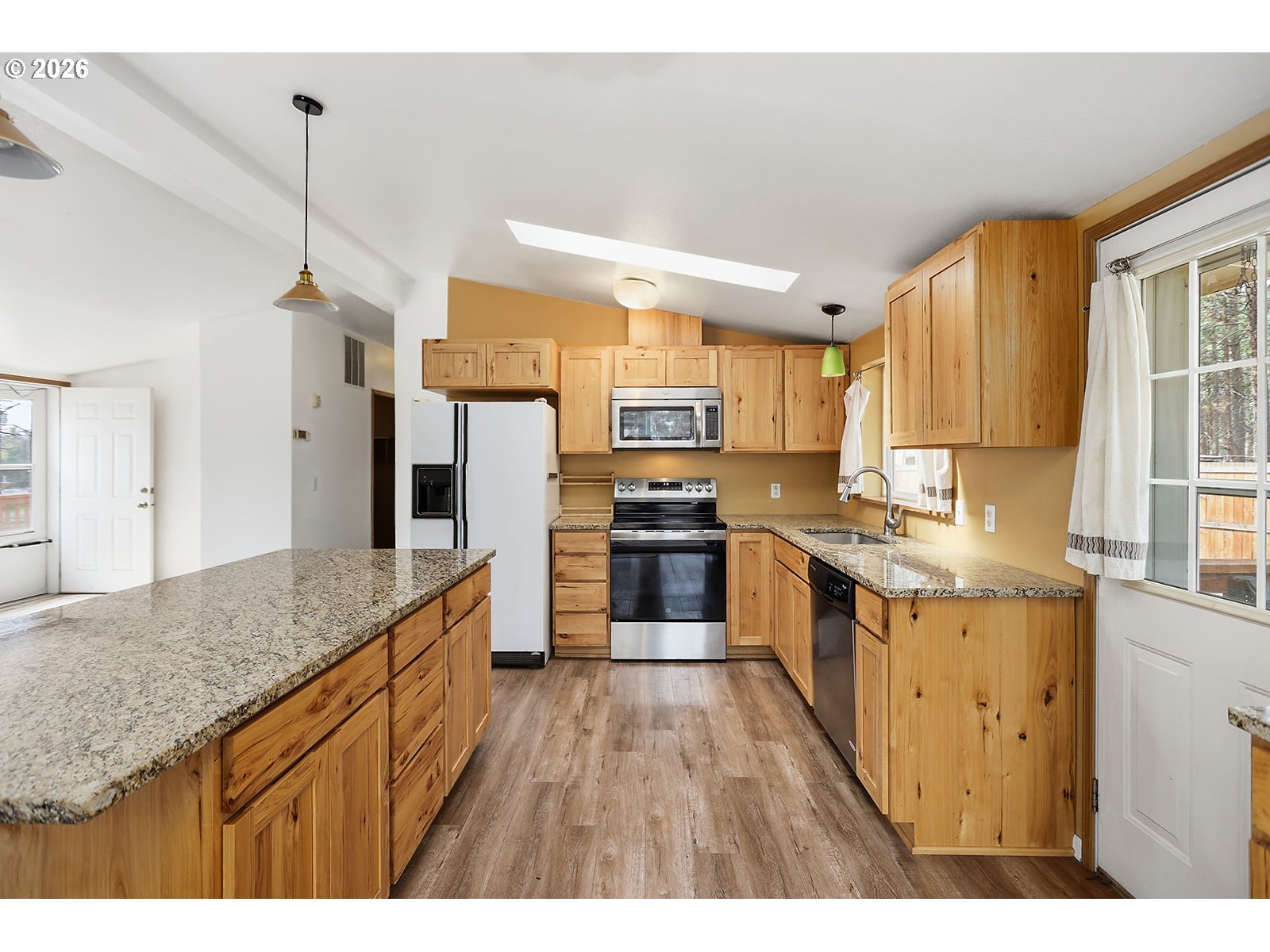 39 North Eagle Point Road Tygh Valley, OR 97063 - Photo 9 of 34 a kitchen with granite countertop a sink counter top space stainless steel appliances and a window