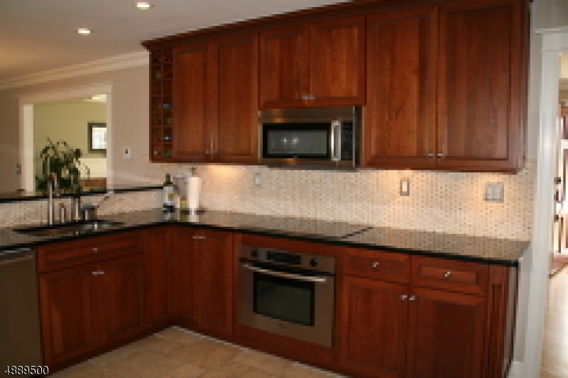 22 Rolling Hill Drive Morristown, NJ 07960 - Photo 6 of 17 a kitchen with granite countertop wooden cabinets and a stove top oven