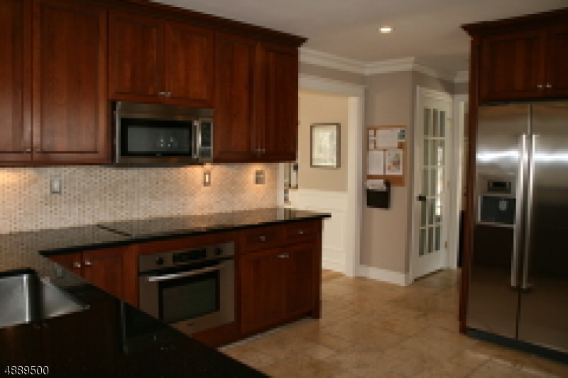 22 Rolling Hill Drive Morristown, NJ 07960 - Photo 7 of 17 a kitchen with granite countertop stainless steel appliances and wooden cabinets