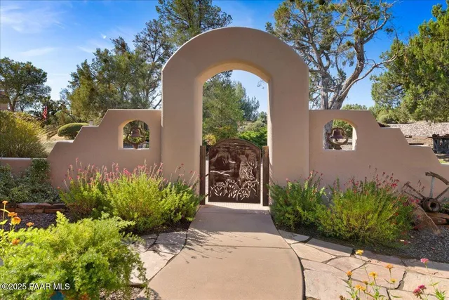 a kitchen with stainless steel appliances lots of white furniture