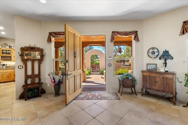 a bed sitting in a spacious bedroom next to a window