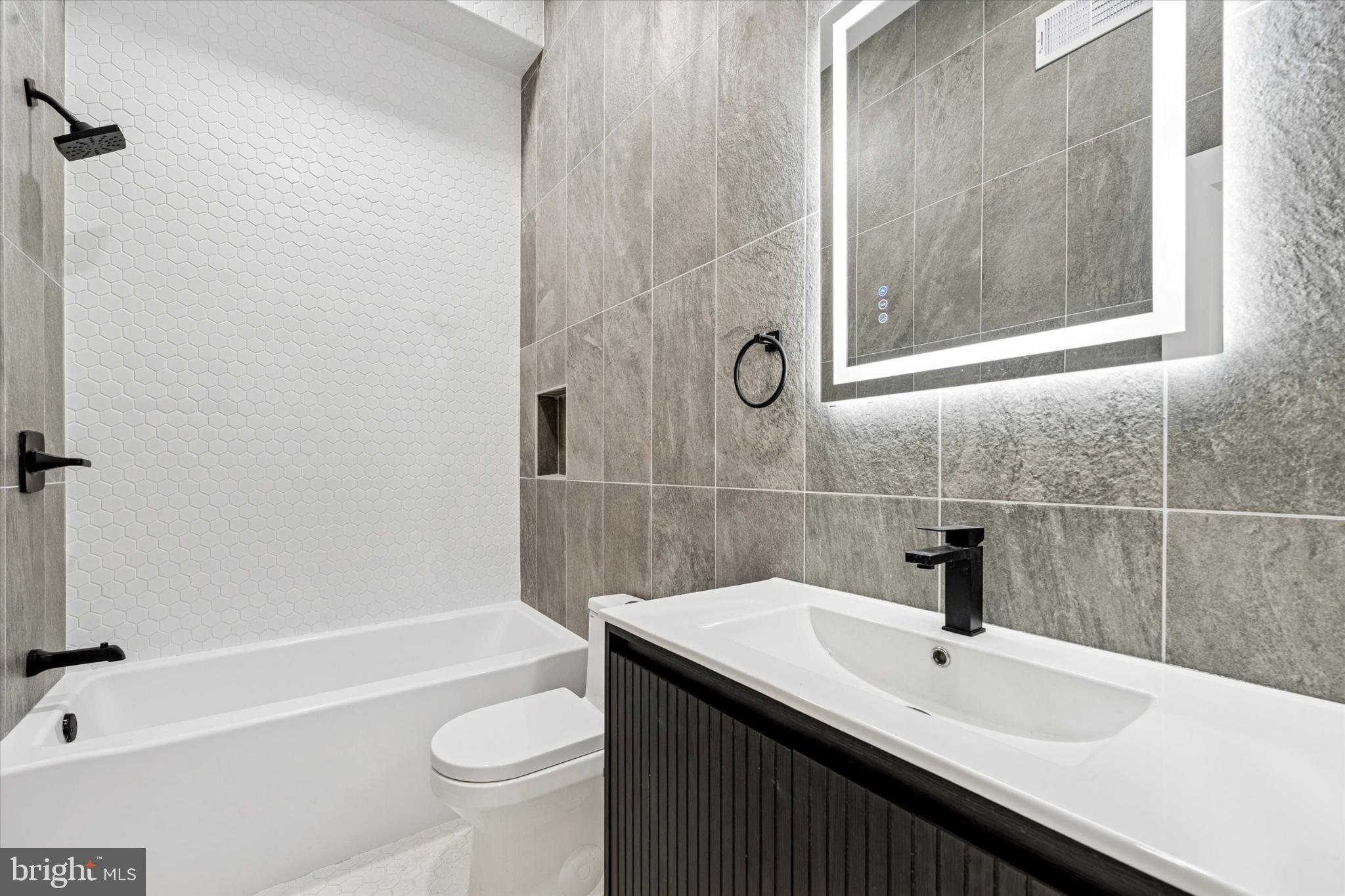 2424 West Thompson Street, Unit 3 Philadelphia, PA 19121 - Photo 11 of 14 a bathroom with a sink a toilet and shower