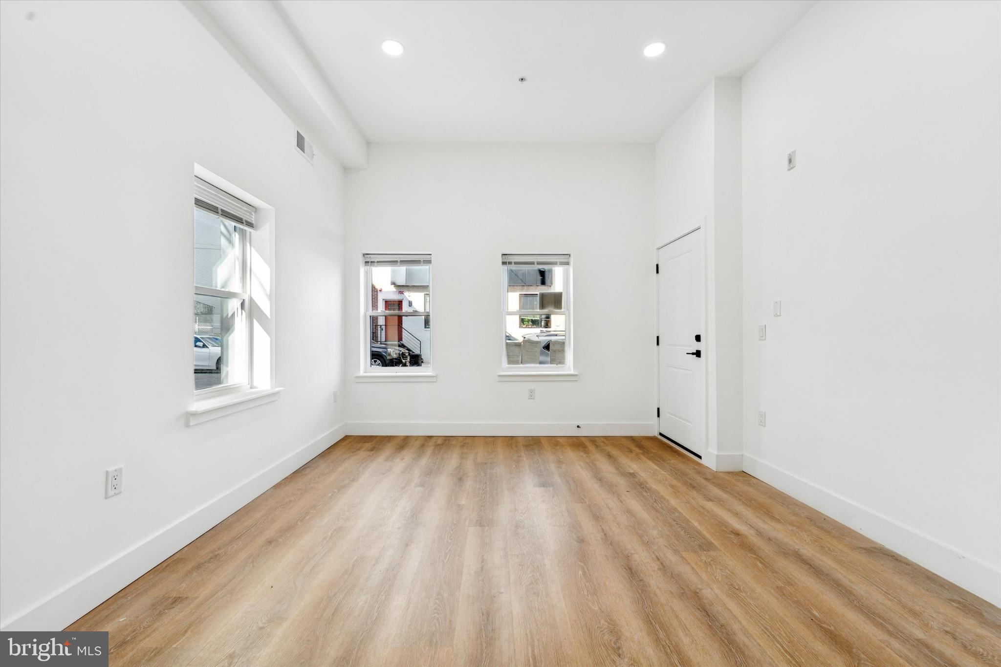 2424 West Thompson Street, Unit 3 Philadelphia, PA 19121 - Photo 8 of 14 wooden floor in an empty room with a window