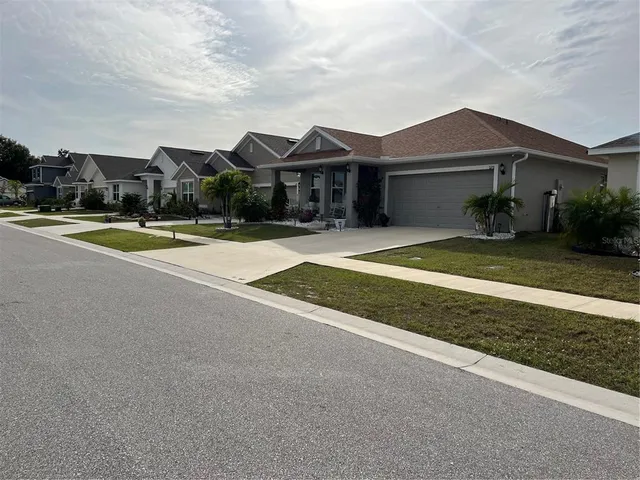 a view of a house with a yard and balcony