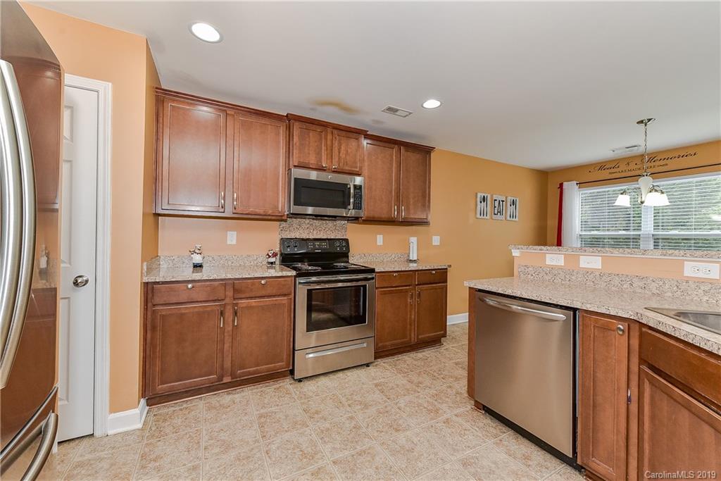 10818 Greenhead View Road Charlotte, NC 28262 - Photo 14 of 39 a kitchen with stainless steel appliances granite countertop a refrigerator sink and stove