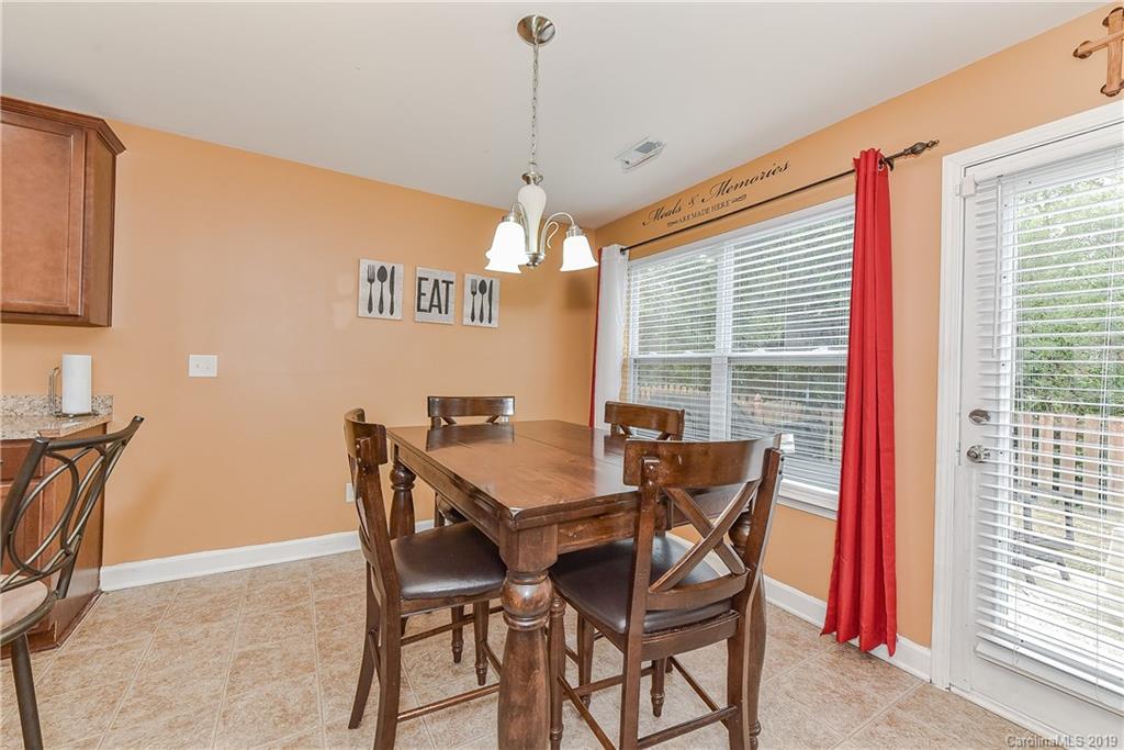 10818 Greenhead View Road Charlotte, NC 28262 - Photo 15 of 39 a view of a dining room with furniture and window