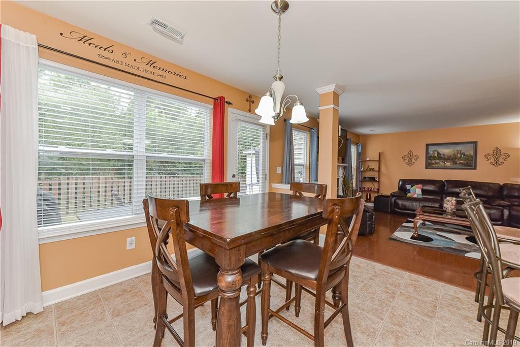 10818 Greenhead View Road Charlotte, NC 28262 - Photo 16 of 39 a view of a dining room and livingroom with furniture large windows a chandelier