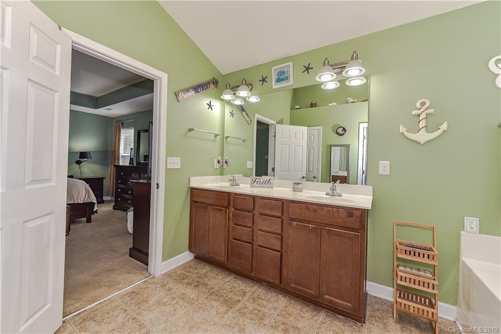 10818 Greenhead View Road Charlotte, NC 28262 - Photo 23 of 39 a spacious bathroom with a double vanity sink and a mirror