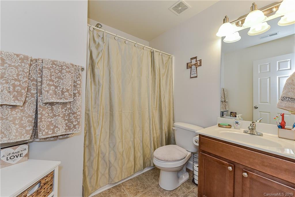 10818 Greenhead View Road Charlotte, NC 28262 - Photo 25 of 39 a bathroom with a sink vanity mirror and toilet