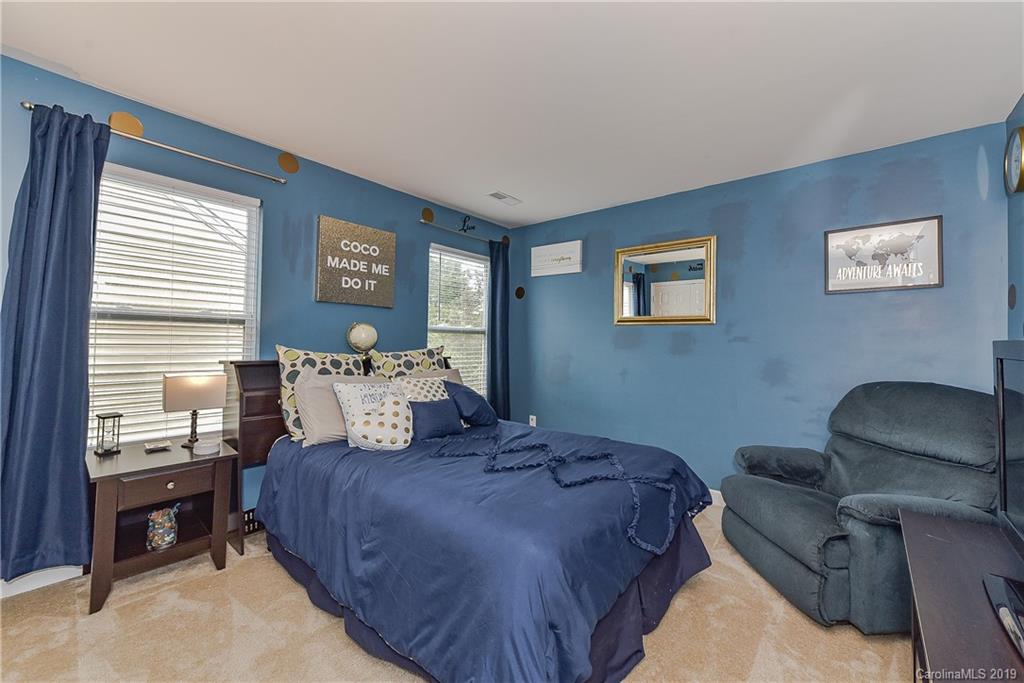 10818 Greenhead View Road Charlotte, NC 28262 - Photo 26 of 39 a bedroom with a bed and a chair