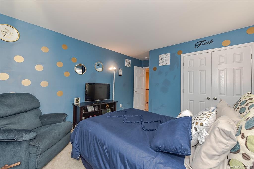 10818 Greenhead View Road Charlotte, NC 28262 - Photo 27 of 39 a bedroom with a bed and a couch
