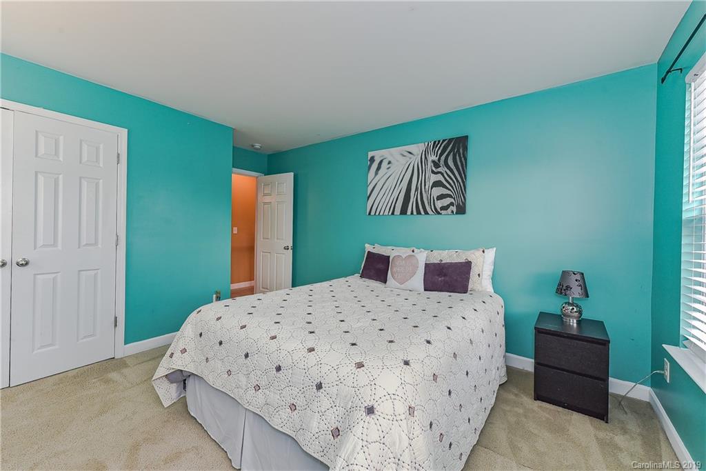 10818 Greenhead View Road Charlotte, NC 28262 - Photo 29 of 39 a bedroom with a bed and a table