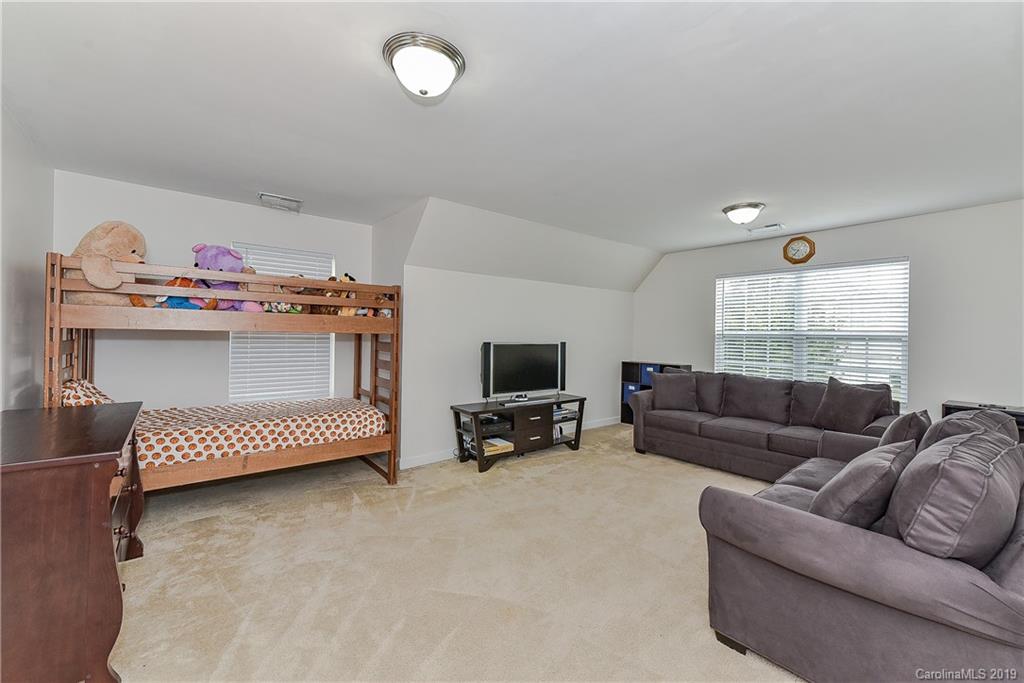 10818 Greenhead View Road Charlotte, NC 28262 - Photo 31 of 39 a living room with furniture and a flat screen tv