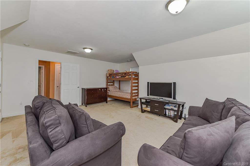 10818 Greenhead View Road Charlotte, NC 28262 - Photo 33 of 39 a living room with furniture and a flat screen tv