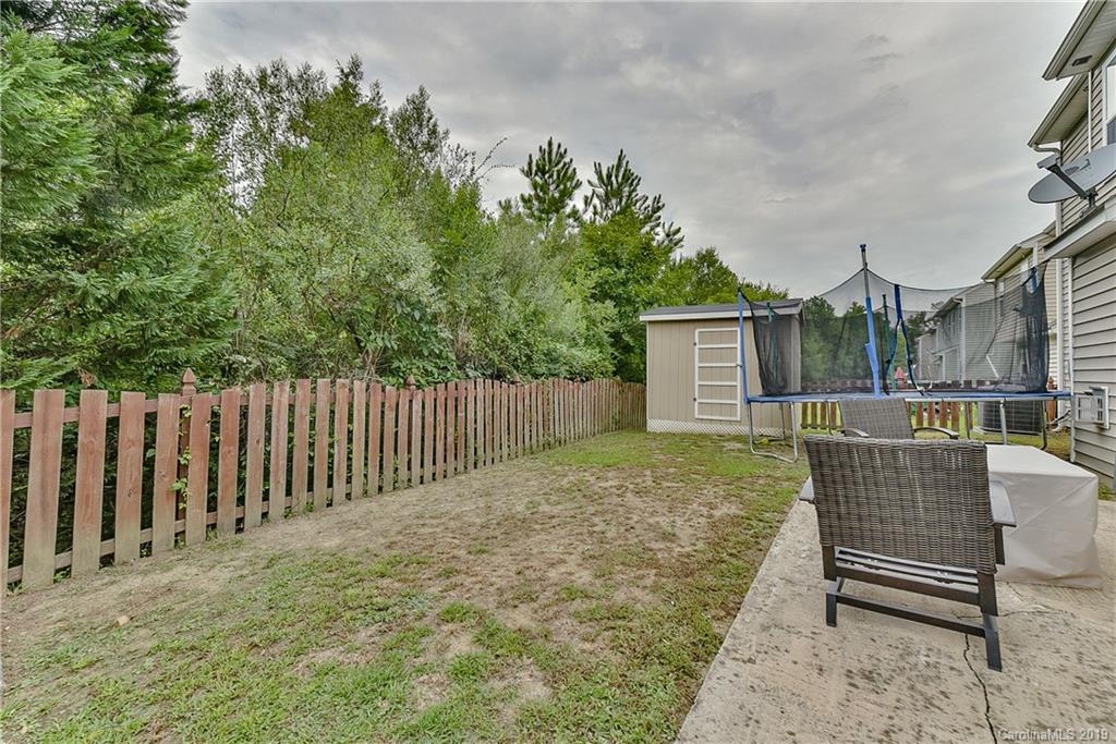 10818 Greenhead View Road Charlotte, NC 28262 - Photo 37 of 39 a view of a backyard with wooden fence and a bench