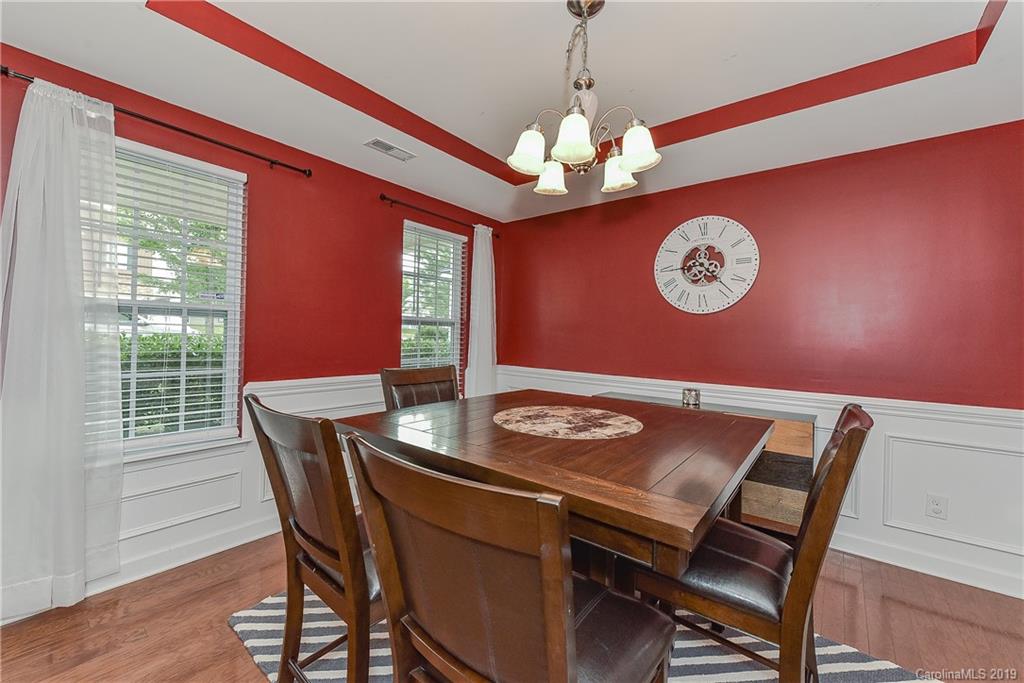 10818 Greenhead View Road Charlotte, NC 28262 - Photo 8 of 39 a view of a dining room with furniture a chandelier and wooden floor