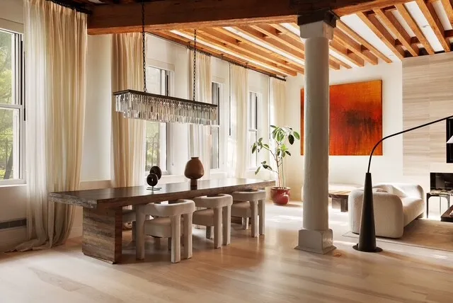 a living room with stainless steel appliances kitchen island granite countertop a sink and cabinets