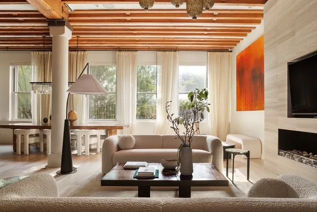 a living room with furniture a rug and a fireplace