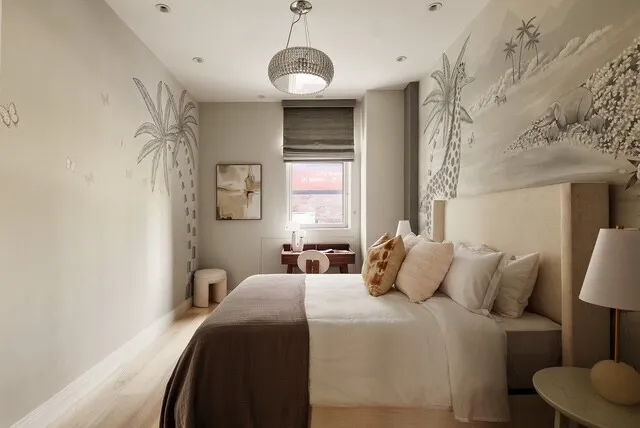 a bedroom with a bed and a painting on the wall