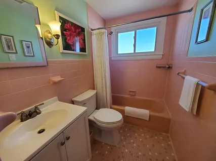 a bedroom with two beds and a chandelier