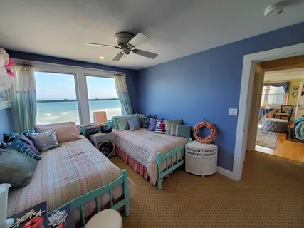 a bedroom with bed and wooden floor