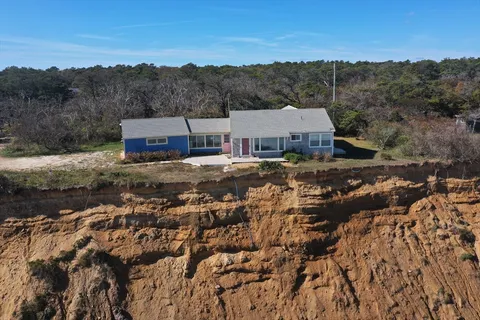 an aerial view of a house with a yard